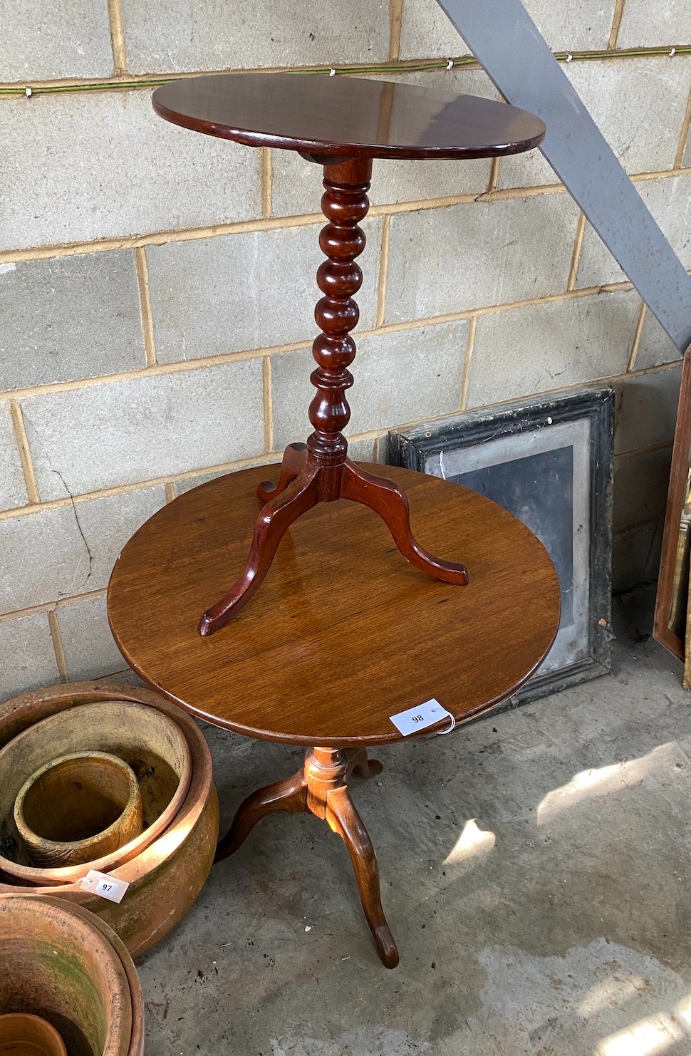 A George III oak tilt top tripod tea table together with a Victorian mahogany bobbin turned tilt top tripod wine table, larger diameter 68cm, height 75cm